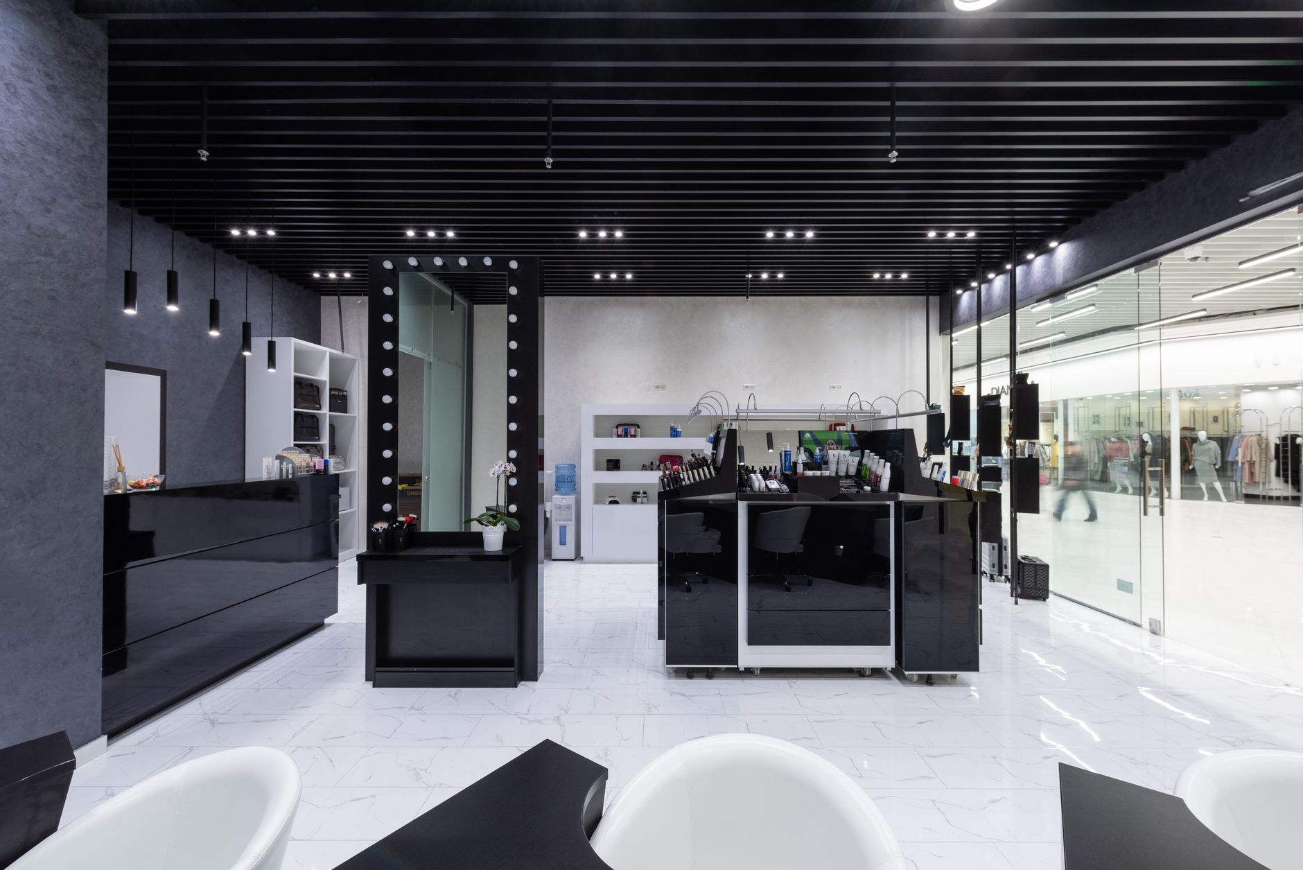 Modern salon interior in black and white with elegant lighting.