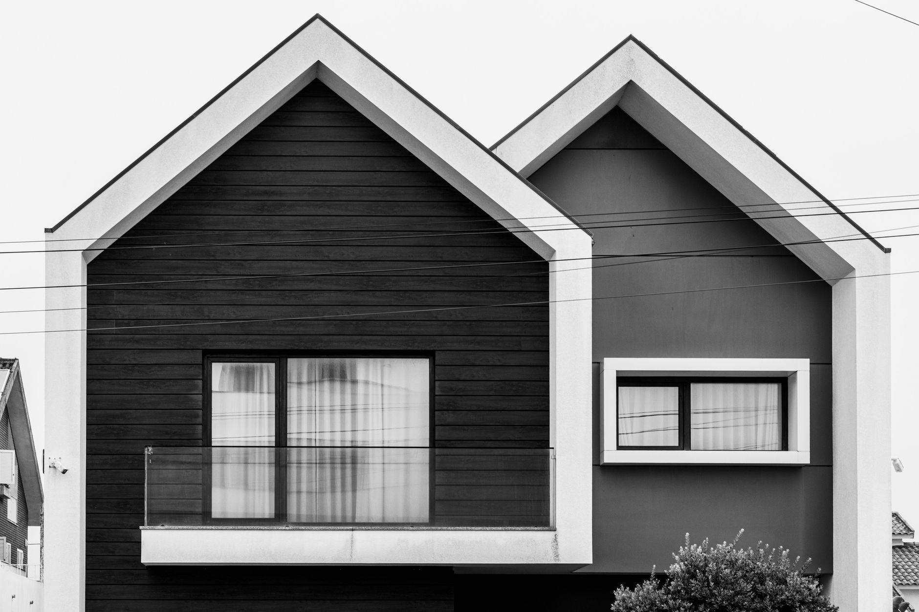 Minimalist facade of a modern house with geometric timber cladding.